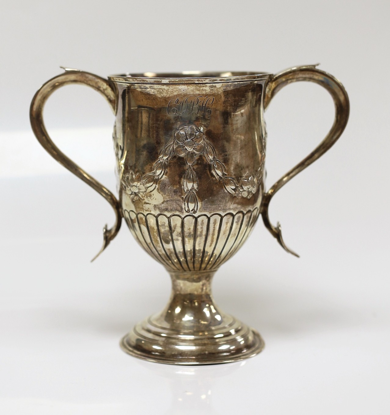 A George III silver two-handled cup, with later embossed decoration, Peter, Ann & William Bateman, London, 1803, height 15.1cm, 9.5oz.